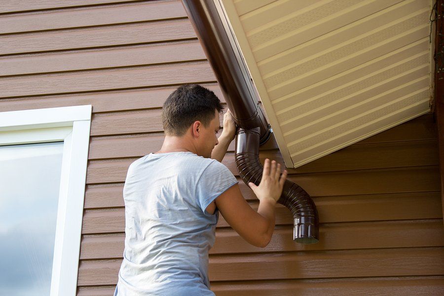 man pushing the roof gutter