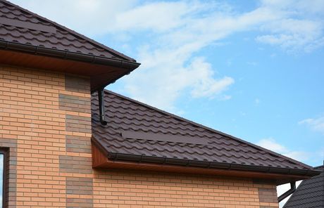 a brick house with galvanized roof