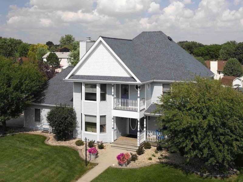 Residential House with White Vinyl Siding and Blue Shingle in Hampton Roads