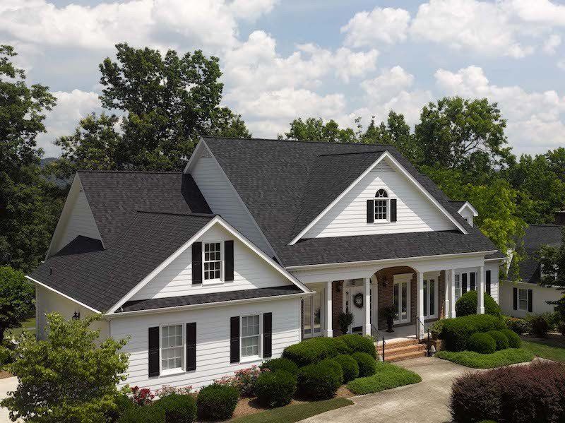 Architectural Asphalt Shingle Residential Roof, Landmark in Charcoal Black. White Vinyl Siding with new White Trim wrap and gutters in Suffolk, VA