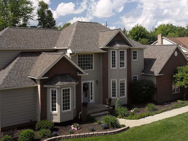 Weathered Wood Landmark Architectural Asphalt Shingle Residential Roof on a 2 story home with white vinyl trim wrap and new white vinyl windows