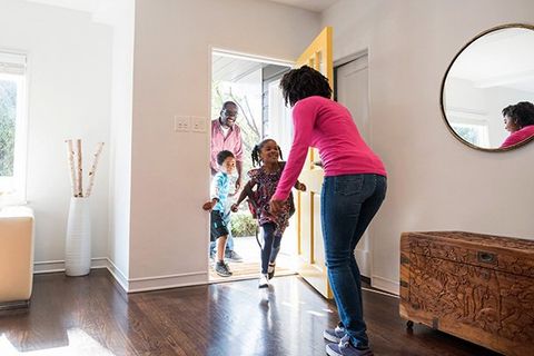 A family of four enters their new home.