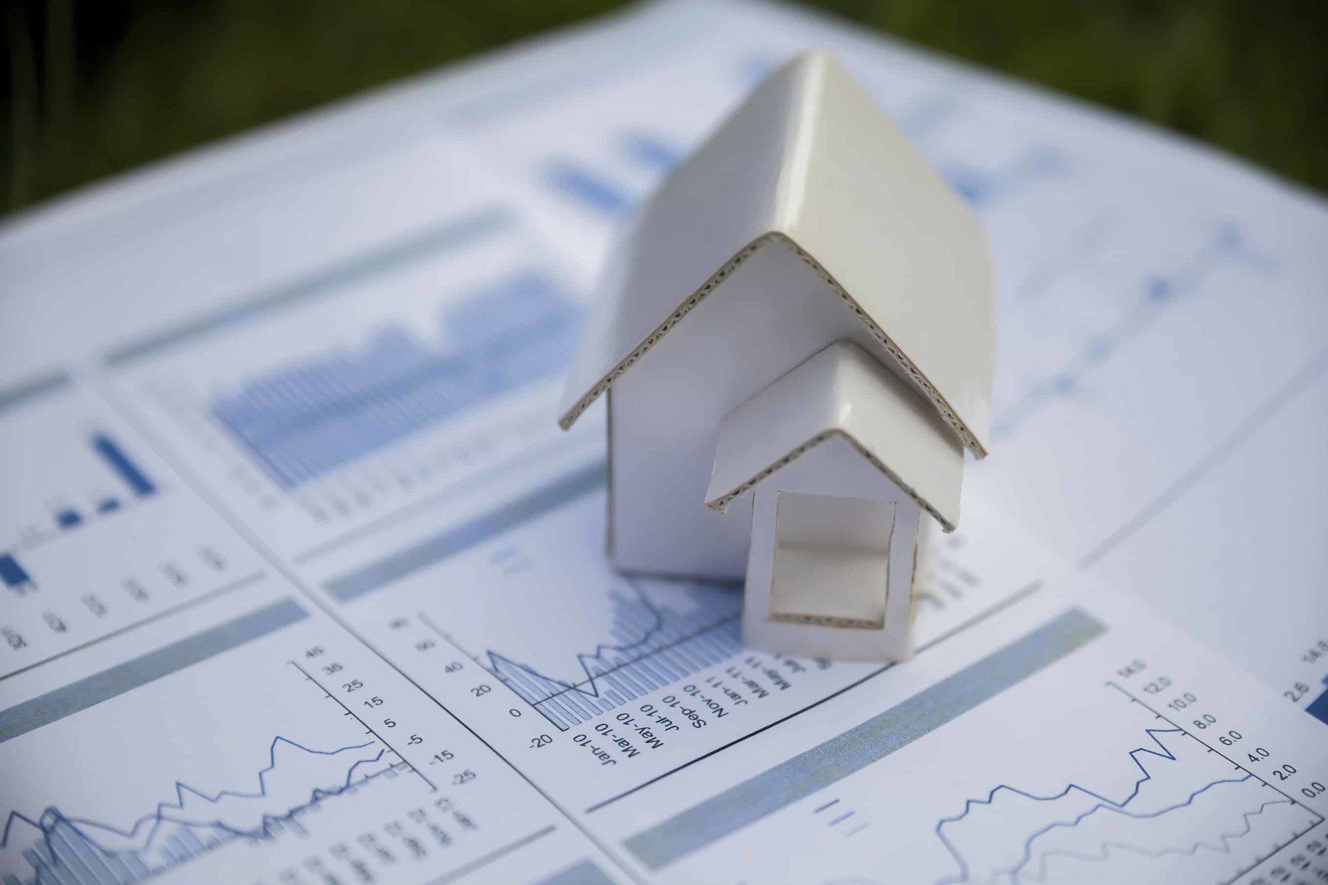 Toy House over accounting graphs representing investment opportunities