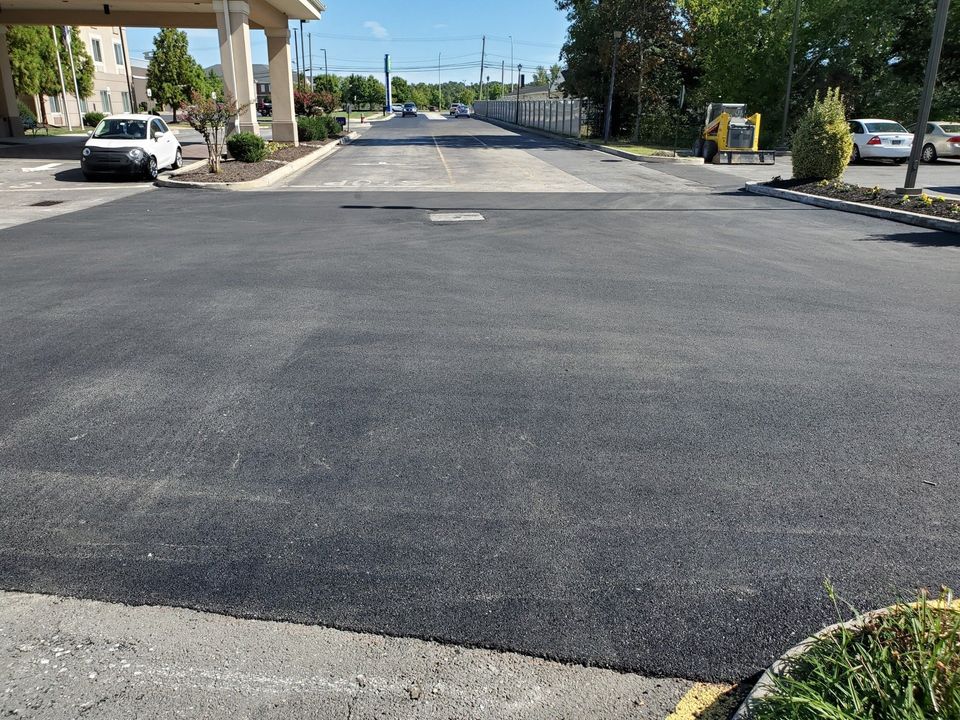 An empty parking lot in front of a motel