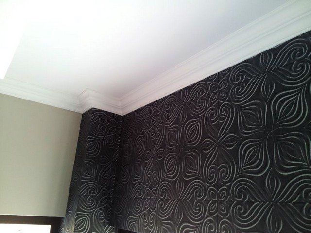 A room with a black wall and a white ceiling.