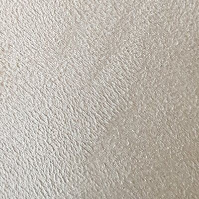 A close up of a piece of paper with a grainy texture.