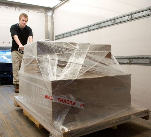 Man shifting storage boxes Man shifting storage boxes