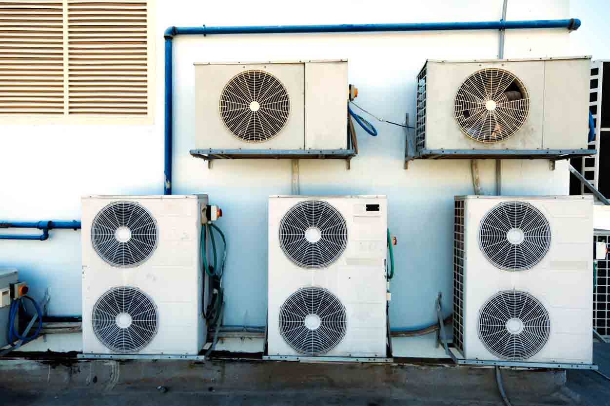 Air conditioning units mounted on a white wall.
