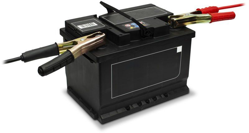 Car battery with jump leads attached, on white background, cut out