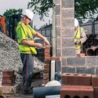 workers laying brick