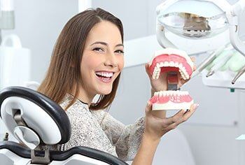 Patient holding model of teeth - Preventive care in Chesnee, SC Patient holding model of teeth - Preventive care in Chesnee, SC