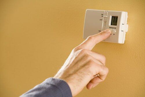 Person adjusting thermostat, Air Conditioning and Heating Systems in Ocean, NJ Person adjusting thermostat, Air Conditioning and Heating Systems in Ocean, NJ
