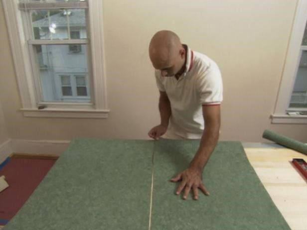 A tradesman cutting wallpaper