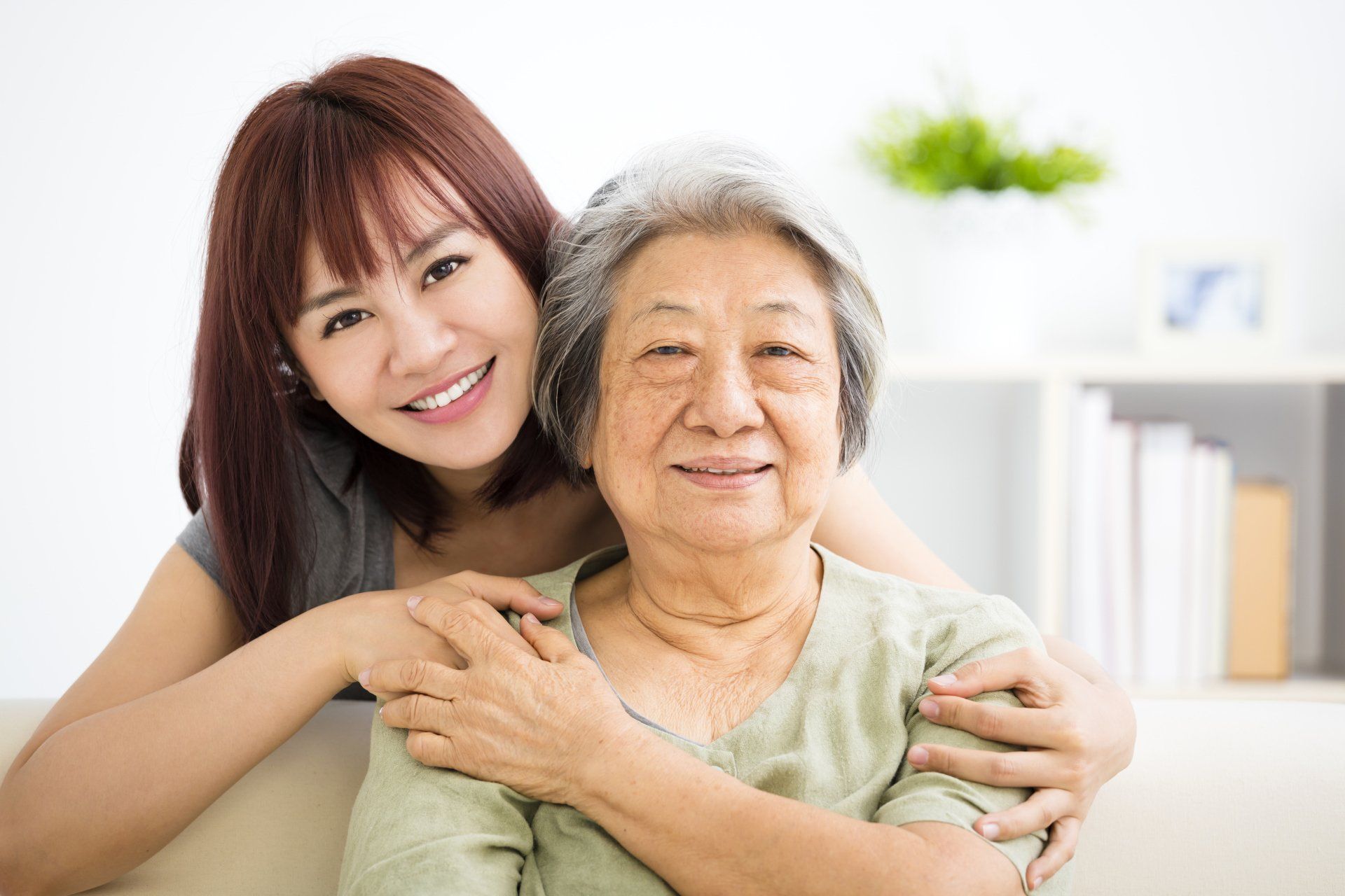 A woman spending time with an elderly family member in her granny flat; accessory dwelling units (ADUs) are popularly known as granny flats because they can be the perfect little backyard home for an elderly parent or relative.