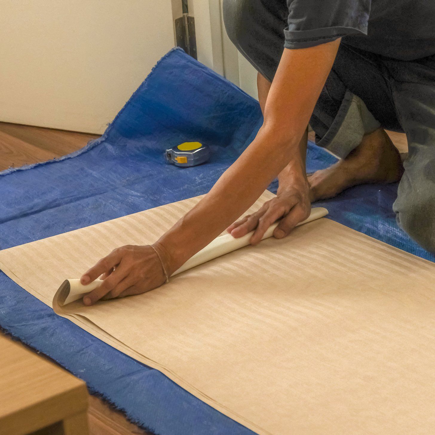 Man Preparing Wallpaper Installation — Sheboygan, WI — Hohmann Painting & Decorating, Inc.