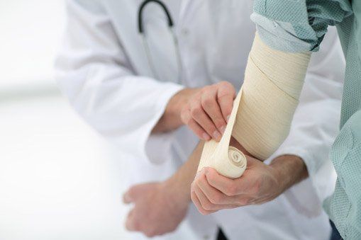 Reconstructive — Doctor Applying Bandage to the Elbow in Lake Success, NY Reconstructive — Doctor Applying Bandage to the Elbow in Lake Success, NY
