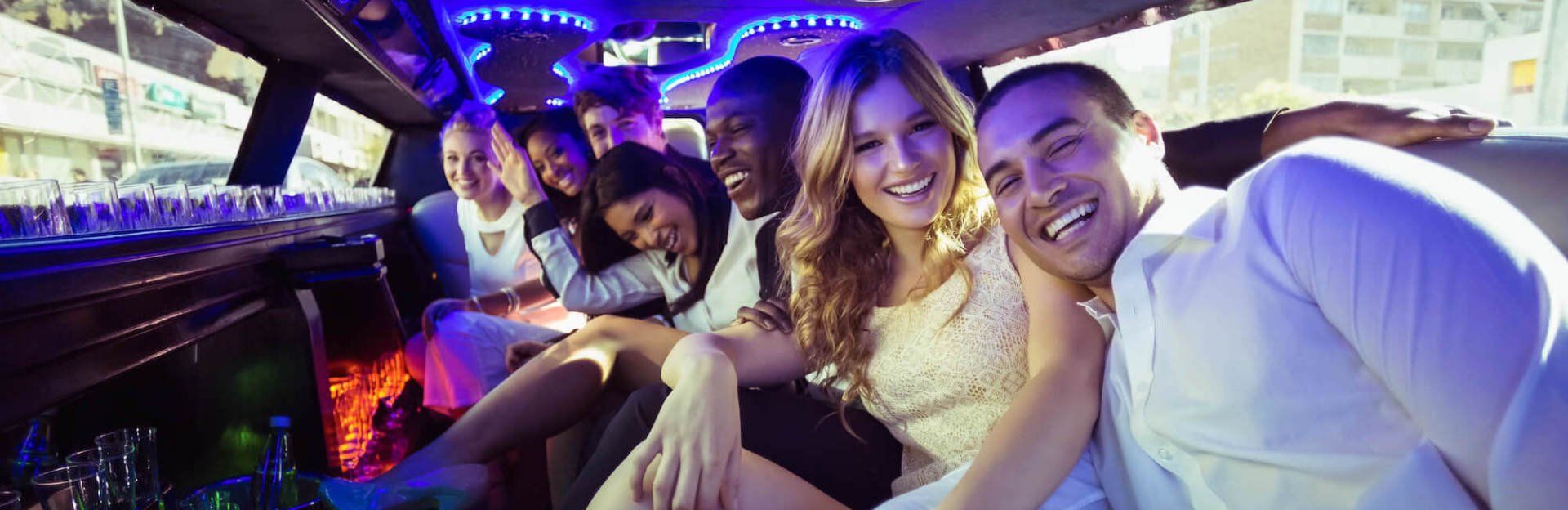 best large group transportation services A group of people are sitting in a limousine.