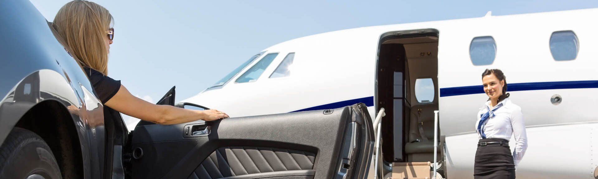 Seattle airport limo service company A woman is getting out of a car next to a private jet.