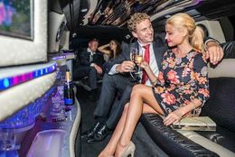 Party Limousine A man and a woman are sitting in a limousine toasting with champagne.