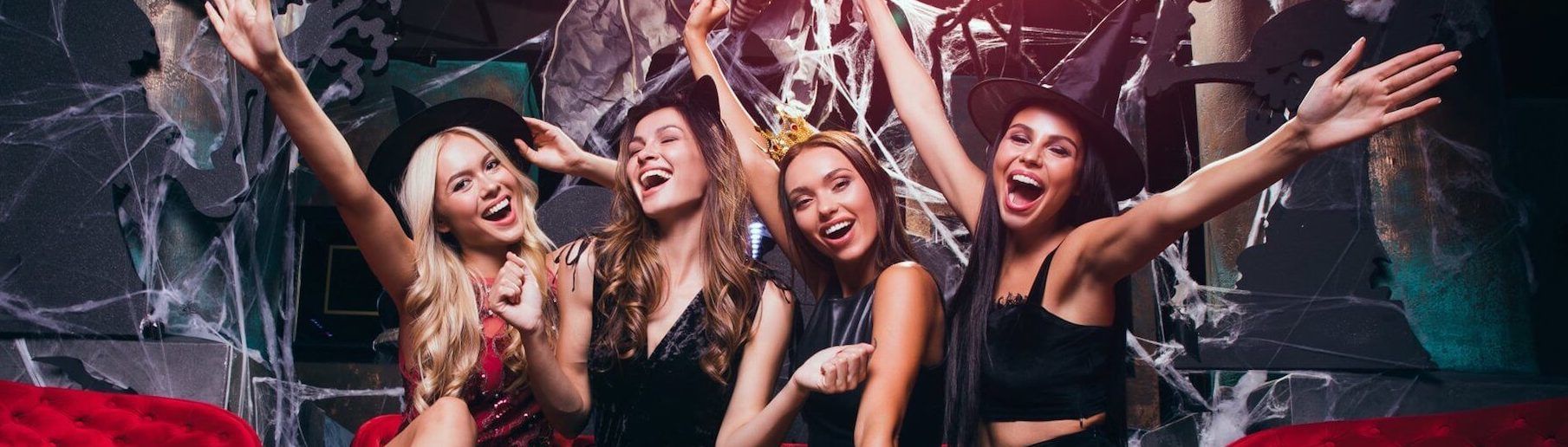FreakNight Festival Limo Service A group of women are standing next to each other with their arms in the air.