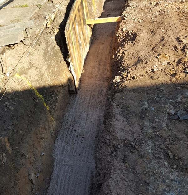 Dug hole with concrete fill