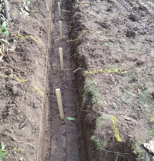 Dug hole with wooden post