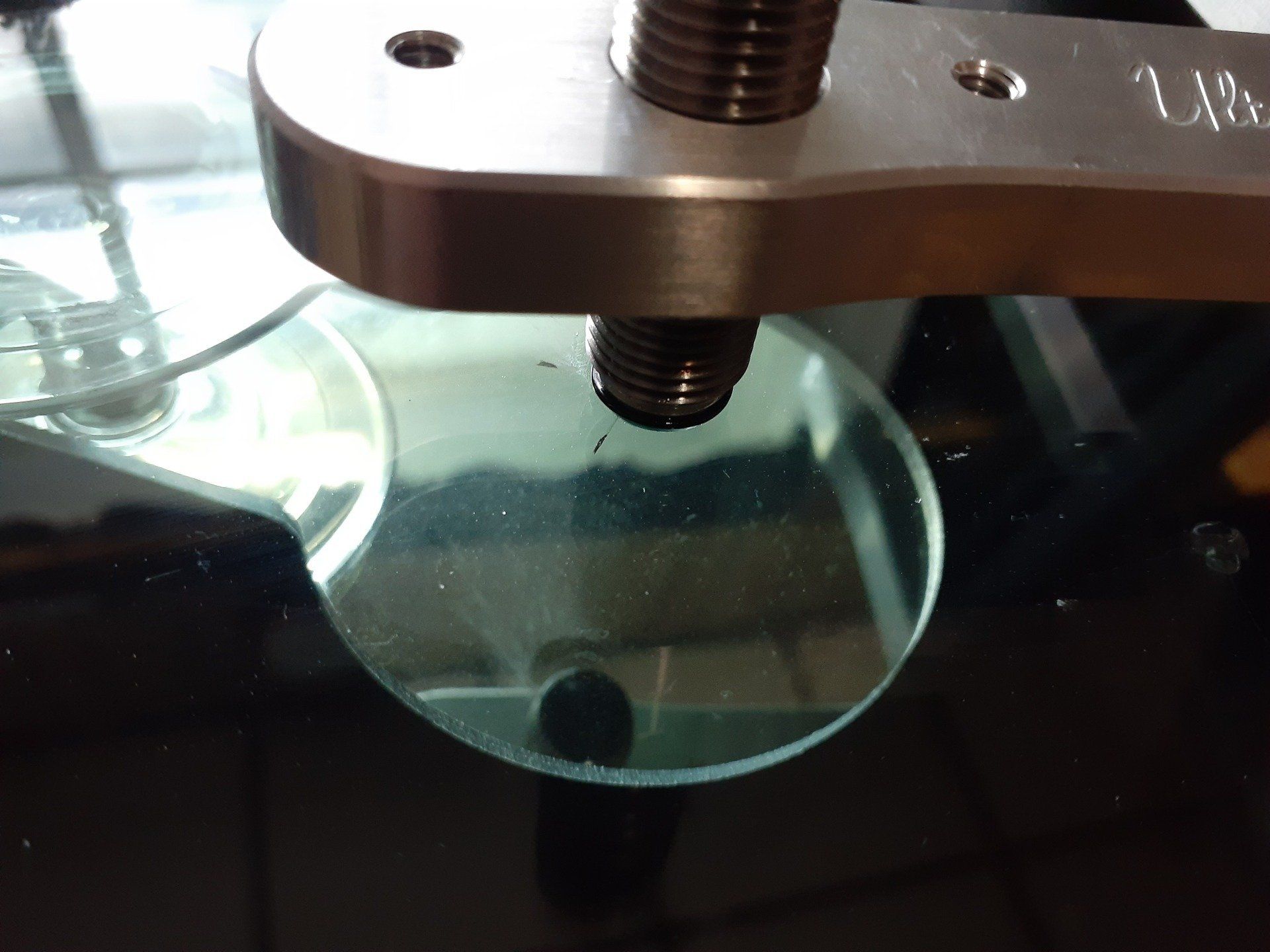A close up of a piece of glass with a wrench on it