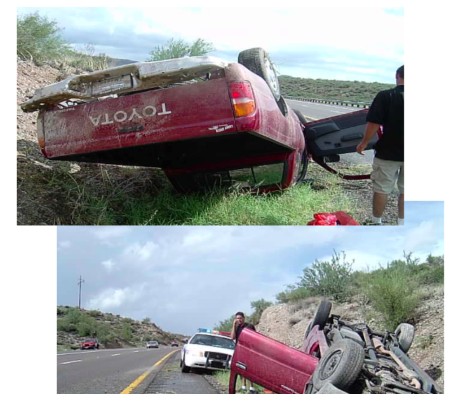 A red toyota truck has rolled over on the side of the road