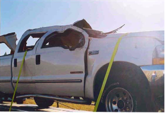 A white truck with a yellow strap around it