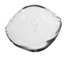 A clear glass ball with a hole in the middle on a white background.