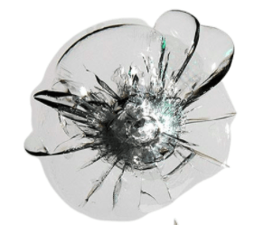 A close up of a broken glass with a hole in it