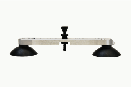 A metal bar with two black suction cups attached to it on a white background.