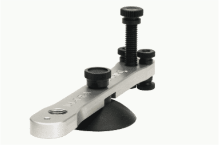 A tool with a screw and a suction cup that says ' acura ' on it