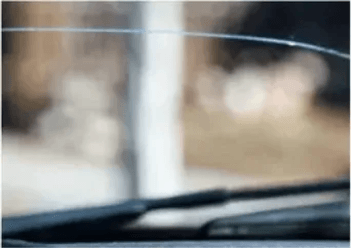 A close up of a windshield with a wiper on it