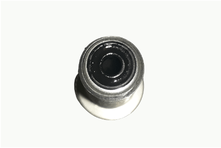 A close up of a ball bearing on a white surface.