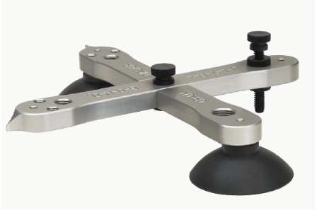 A metal object with a black suction cup on a white background.
