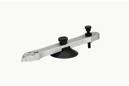 A close up of a tool with a suction cup on a white background.