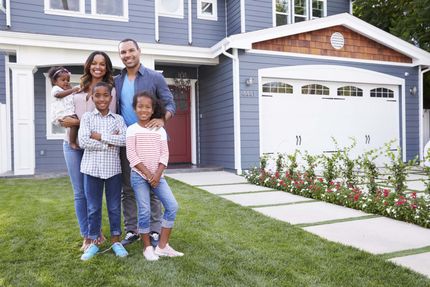 family-in-front-of-house-