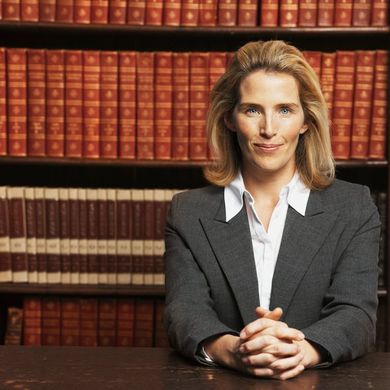 Attorney in front of bookshelves — law firm in Los Angeles, CA Attorney in front of bookshelves — law firm in Los Angeles, CA