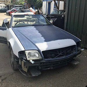 vintage car with damaged bumper