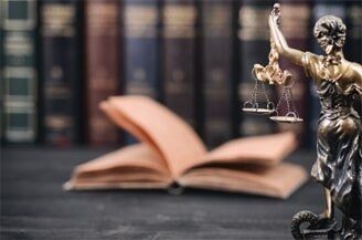 Attorney — Justice Scale With Books In Background in El Paso, TX Attorney — Justice Scale With Books In Background in El Paso, TX