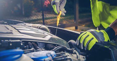 Service Center — Mechanic Inspecting a Car in Laredo, TX Service Center — Mechanic Inspecting a Car in Laredo, TX