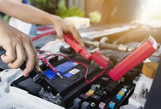 Battery Service — Mechanic Checking the Car Battery in Laredo, TX Battery Service — Mechanic Checking the Car Battery in Laredo, TX