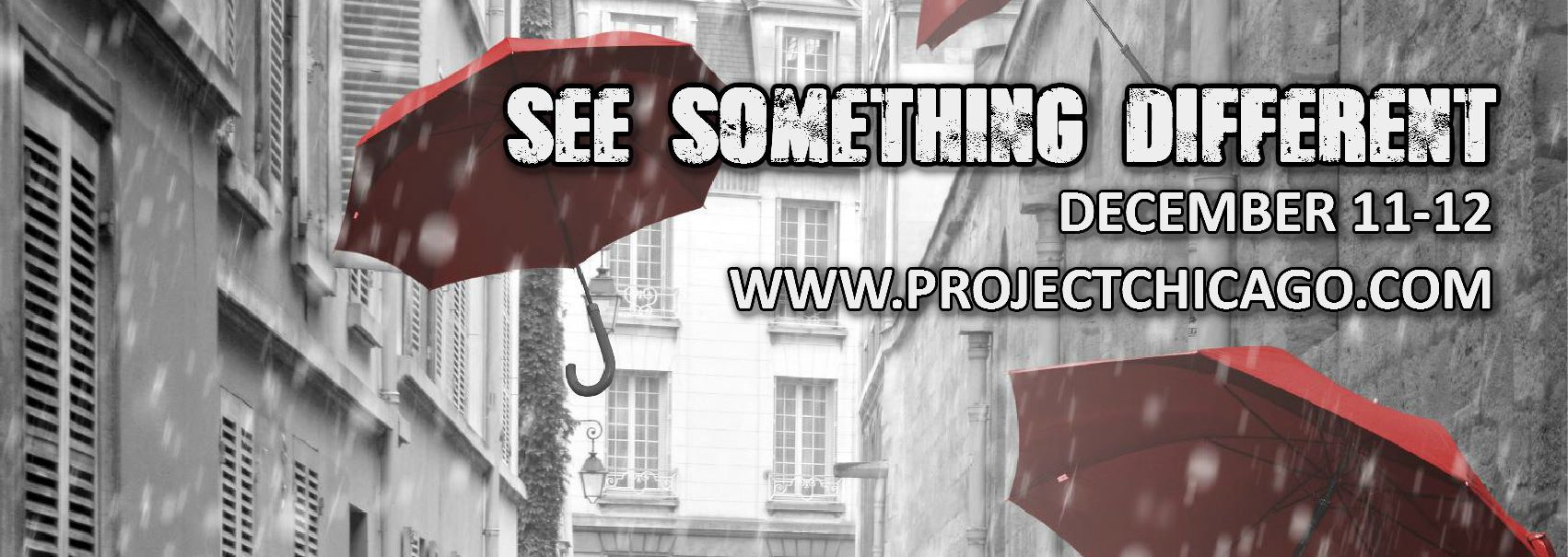 Black and white street scene with red umbrellas,