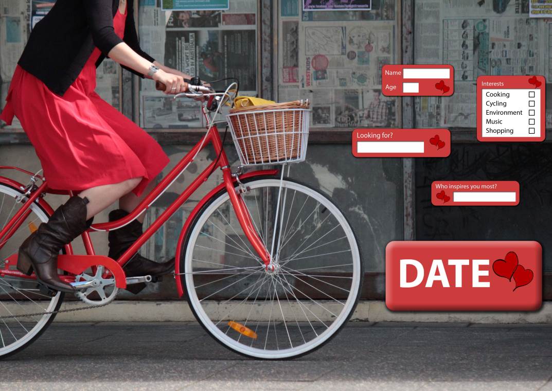 Woman on red bike, red dress, basket, date boxes, urban setting.