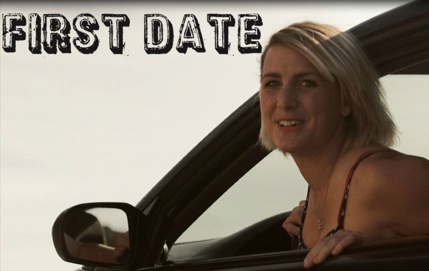 Blond woman in a car looking out window,