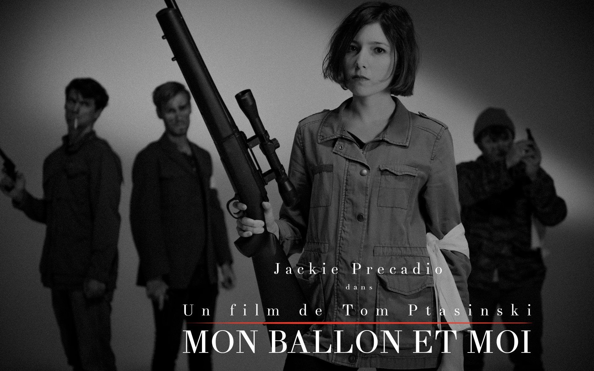 Group of people in black and white with guns, a woman holding a sniper rifle.