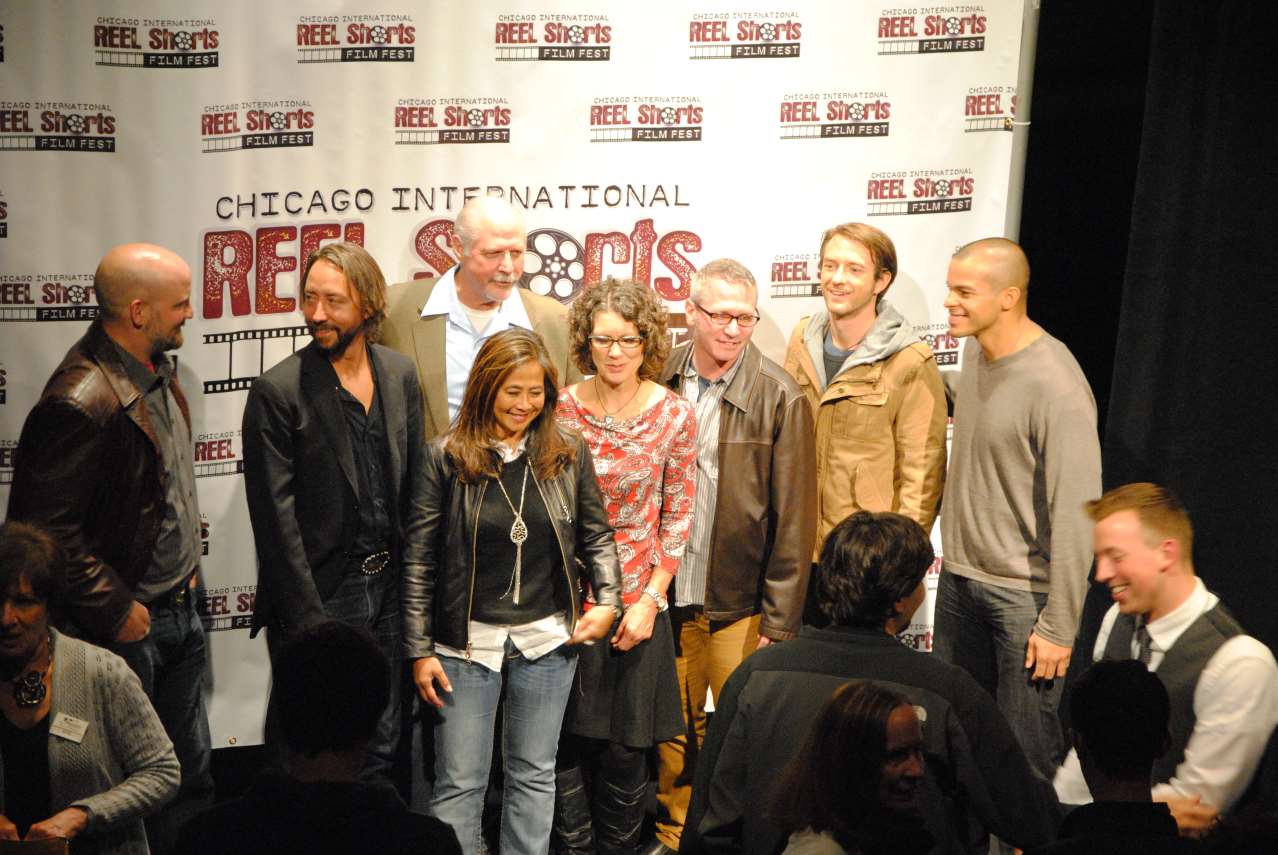 Group of people at a Chicago sports film festival, posing in front of a backdrop.