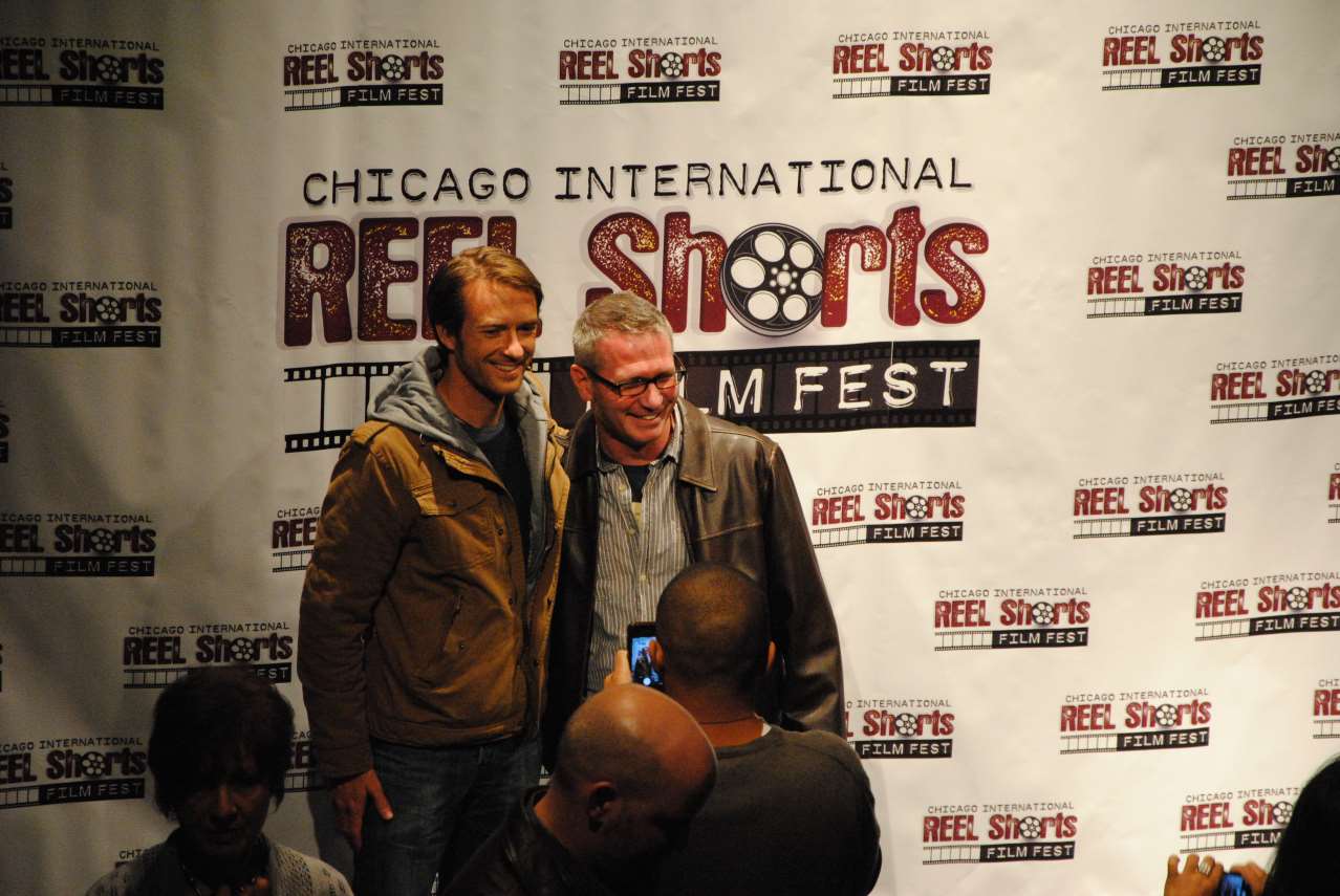 Two men smiling, posing for a photo at the Chicago Reel Shorts Film Fest.