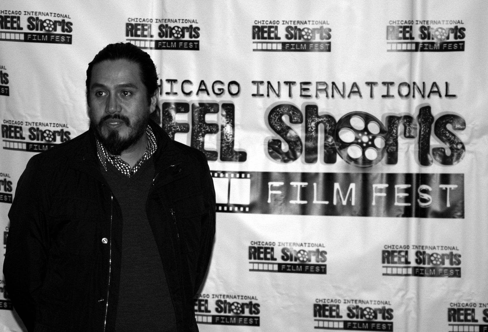 Man with beard at the Chicago International Reel Shorts Film Fest, black and white photo.
